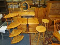 A HONEY PINE DRESSING TABLE, MIRROR, THREE STOOLS, A PAIR OF BEDSIDE CHESTS AND A WOT-NOT