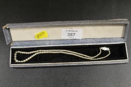 A 9CT WHITE CLASP STRING OF FAUX PEARLS