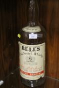 AN EMPTY 4.5 LITRE BELLS WHISKY BOTTLE