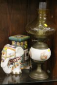 A DECORATIVE CERAMIC ELEPHANT TOGETHER WITH A VINTAGE OIL LAMP