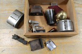 A CIGAR HUMIDOR BOX CONTAINING CIGARETTE LIGHTERS, CIGAR CUTTERS, ETC