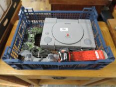 A TRAY CONTAINING PLAYSTATION 1 AND TWO HAND CONTROLLERS
