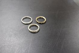 THREE ASSORTED GEMSET ETERNITY RINGS