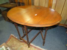 AN OAK BARLEYTWIST DROPLEAF TABLE