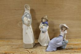 A LLADRO FIGURE OF A GIRL HOLDING A LAMB TOGETHER WITH TWO NAO FIGURES (ONE A/F)