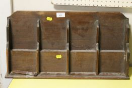 A VINTAGE WOODEN STATIONARY SHELF 