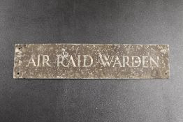 A VINTAGE 'AIR RAID WARDEN' METAL PLAQUE