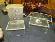 A SMALL SILVER FOUR DRAWER CHEST PLUS A NEST OF GLASS / METAL TABLES (2)