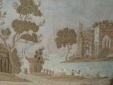 AN ANTIQUE WOOLWORK WOODED RIVER SCENE WITH ANGLERS AND ABBEY RUINS