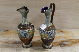 AN ANTIQUE ROYAL DOULTON LAMBETH WARE EWER DECORATED WITH DOVES TOGETHER WITH ANOTHER (THE LATTER