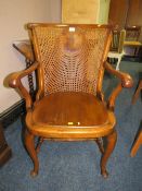 A VINTAGE WALNUT BERGERE ARMCHAIR