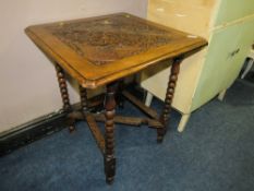 AN ANTIQUE OAK CARVED DROP LEAF TABLE