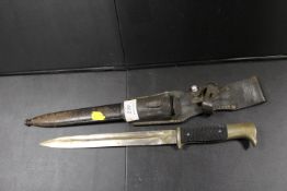 A VINTAGE STYLE BAYONET WITH METAL SHEATH AND LEATHER BELT-LOOP HOLDER