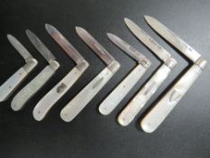 SEVEN VARIOUS HALLMARKED SILVER BLADED FRUIT KNIVES WITH MOTHER OF PEARL HANDLES