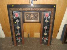 A CAST IRON FIRE SURROUND WITH TUBELINED TILES