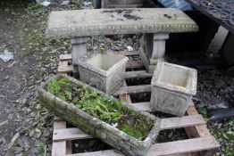 A CONCRETE GARDEN BENCH PLUS THREE CONCRETE PLANTERS
