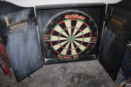 A WINMAU BLADE III DART BOARD AND SURROUND