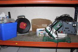 A SELECTION OF TOOLS TO INCLUDE 3.5 KW EXTENSION LEAD, A LARGE BATTERY CHARGER , A POWERED MITRE SAW