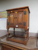 A SMALL OAK LINENFOLD CABINET
