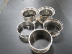 FIVE HALLMARKED SILVER NAPKIN RINGS