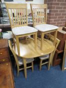 A MODERN KITCHEN TABLE AND FOUR CHAIRS