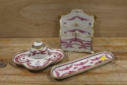 A THREE PIECE DRESDEN DESK SET COMPRISING INKWELL, LETTER RACK AND PEN TRAY