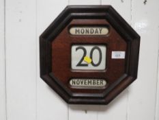 A VINTAGE WOODEN ADJUSTABLE WALL CALENDAR