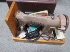 A VINTAGE CASED ELECTRIC SINGER SEWING MACHINE