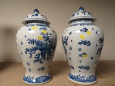 A PAIR OF BLUE/WHITE LIDDED VASES