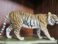 A RESIN FIGURE OF A WALKING TIGER