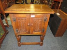 A SMALL OAK GOTHIC STYLE BEDSIDE CABINET