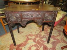 AN ANTIQUE CARVED OAK LOWBOY WITH THREE FRIEZE DRAWERS - W 77 cm