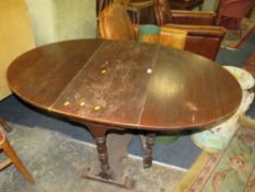 A HEAVY OAK DROPLEAF GATELEG TABLE