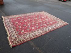 A LARGE EASTERN WOOLLEN RUG 336 cm x 233 cm
