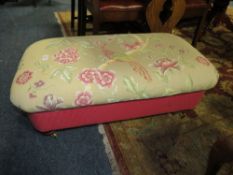 AN UPHOLSTERED STOOL