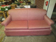 A LARGE PINK UPHOLSTERED SETTEE