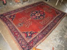 AN ANTIQUE WOOLLEN RUG 242 x 152 cm