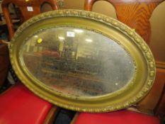 A VINTAGE GILT OVAL WALL MIRROR