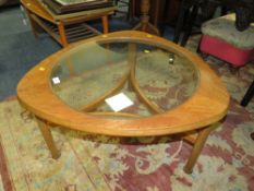 A RETRO TEAK AND GLASS SHAPED COFFEE TABLE - H 44 cm, W 76 cm