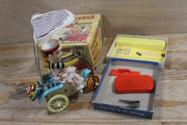 A VINTAGE BOXED CLOCKWORK TRICYCLE WITH BELL, TOGETHER WITH A VINTAGE BOXED JOHN BULL PRINTING