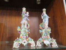 A PAIR OF ORNATE CONTINENTAL STYLE FIGURAL CANDLESTICKS TOGETHER WITH A SMALL CONTINENTAL FIGURE