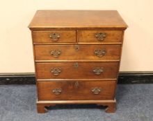 A 19TH CENTURY CHEST OF SMALL PROPORTIONS, having two short above three longer graduated drawers,