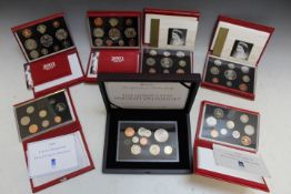A CASED 'NEW QUEEN'S PORTRAIT' SPECIMEN COIN SET, together with a 1990 Royal Mint proof set, a