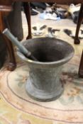 A LARGE AND HEAVY BRONZE PESTLE AND MORTAR, H 32 cm, Dia. 35 cm