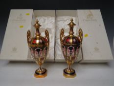 A PAIR OF BOXED ROYAL CROWN DERBY OLD IMARI PATTERN TWIN HANDLED LIDDED VASES / URNS, pattern no.