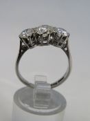 A LADIES MID CENTURY THREE STONE DIAMOND RING, the shank marked 18ct & Plat., large central stone