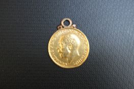 A GEORGE V FULL SOVEREIGN DATED 1912, with suspension ring mount