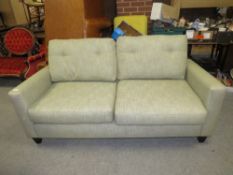 A MODERN UPHOLSTERED SETTEE