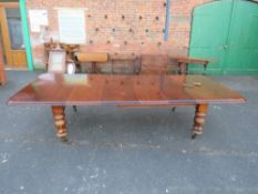A MID VICTORIAN LARGE WIND-OUT DINING TABLE WITH FOUR LEAVES, raised on four heavy acanthus