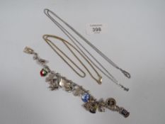 A SILVER CHARM BRACELET AND TWO SILVER NECK CHAINS